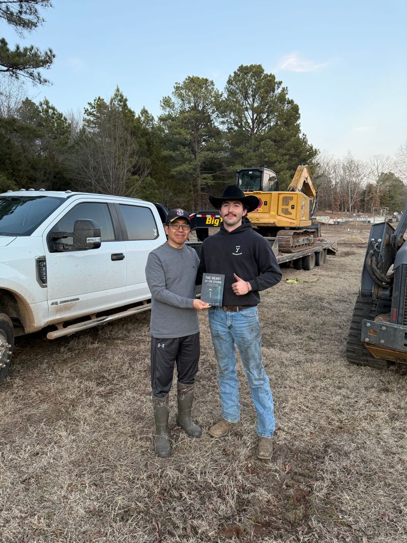 Austin Brice with a satisfied customer on a job site in Arkansas