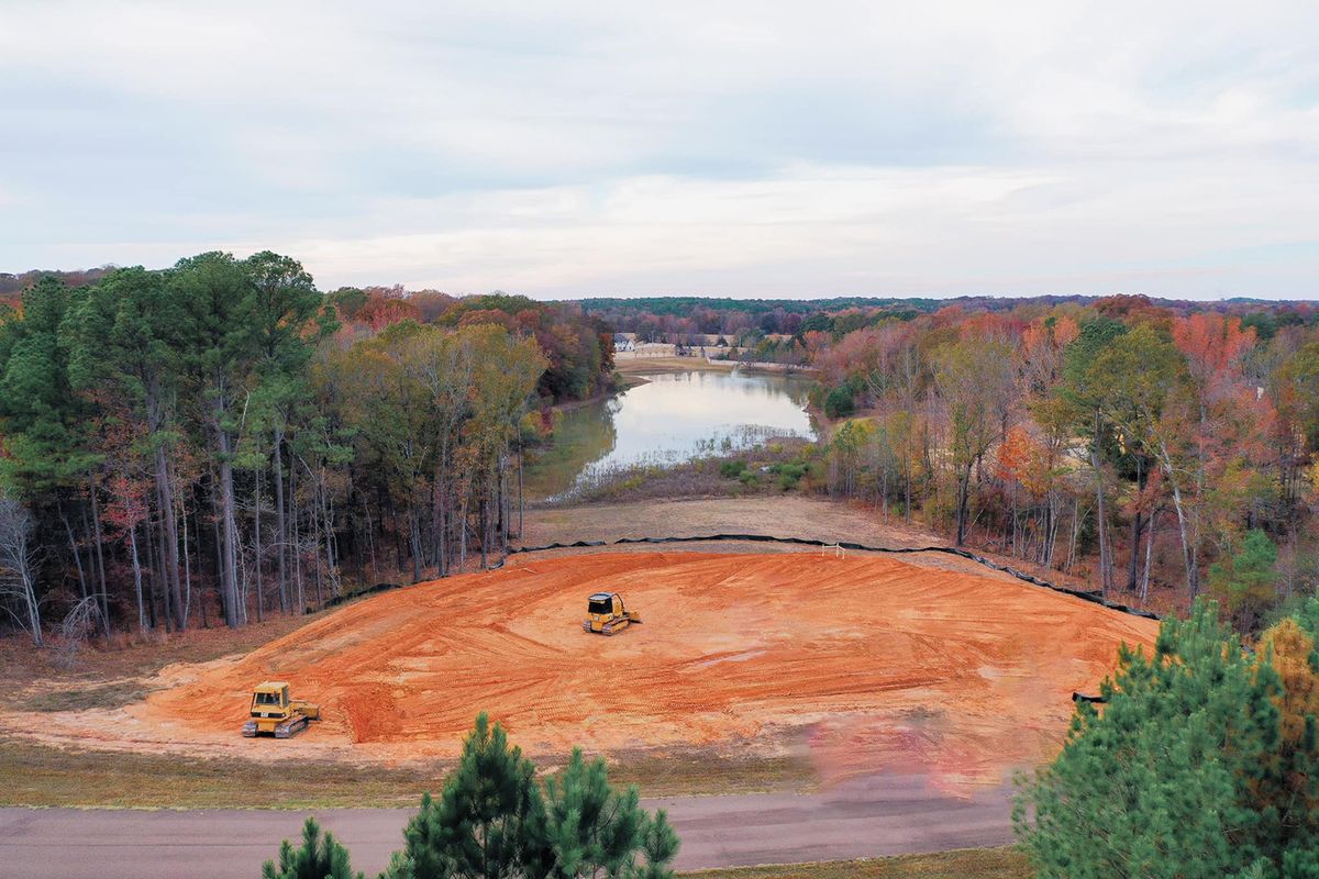 Heavy equipment removing trees during active land clearing
