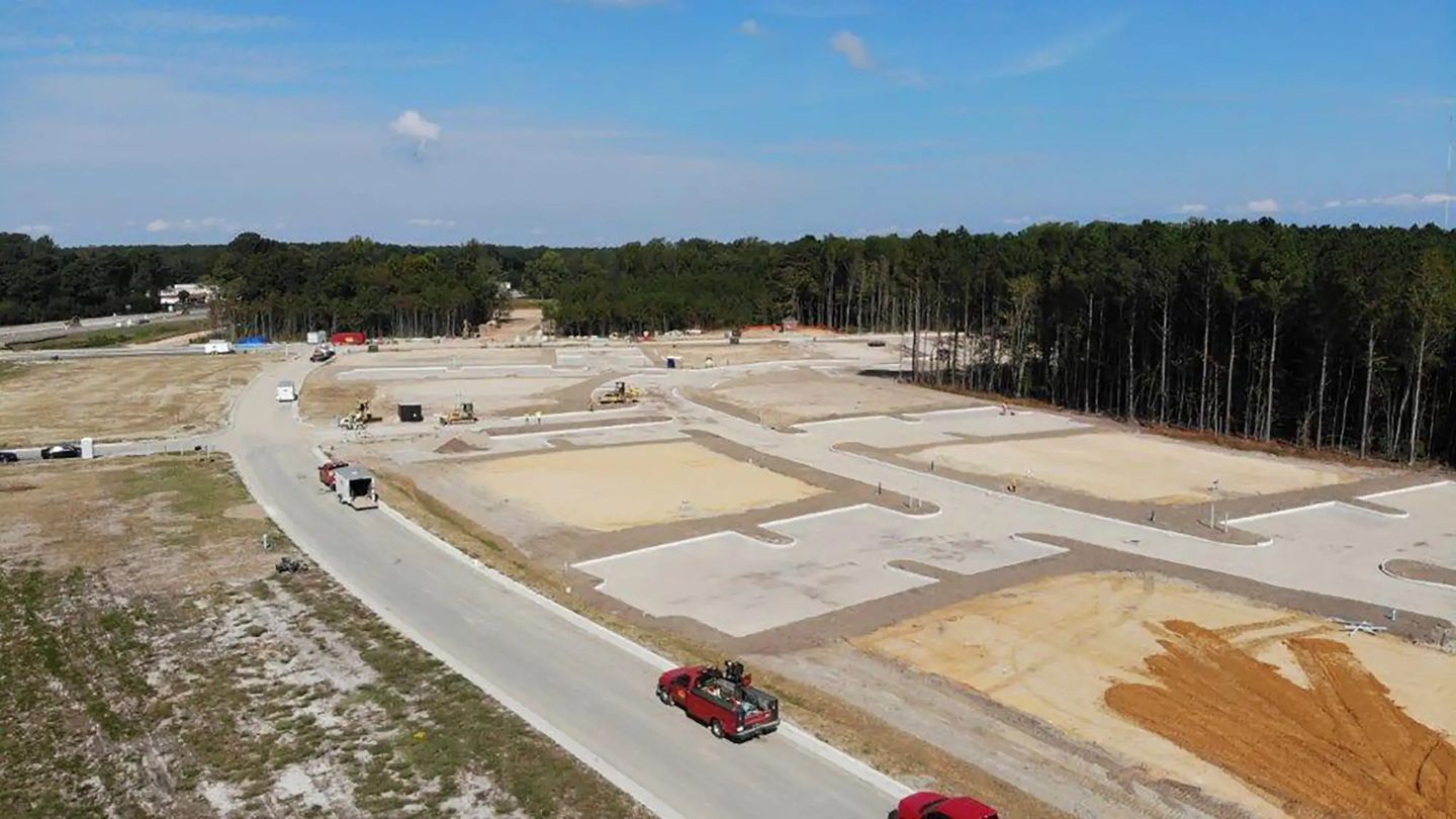 Excavators installing underground utilities in a new residential development
