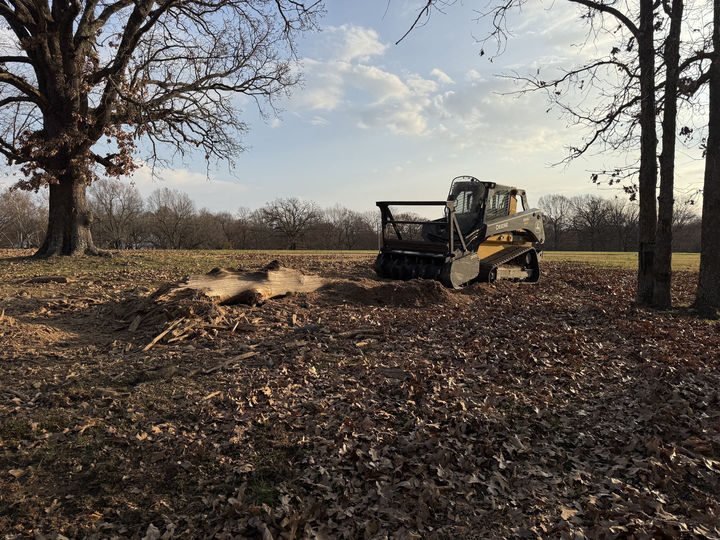 Excavator clearing wooded land on an Arkansas property