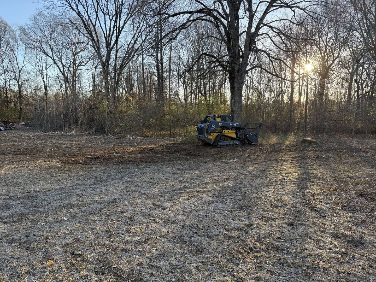 Land clearing in progress on wooded Arkansas terrain