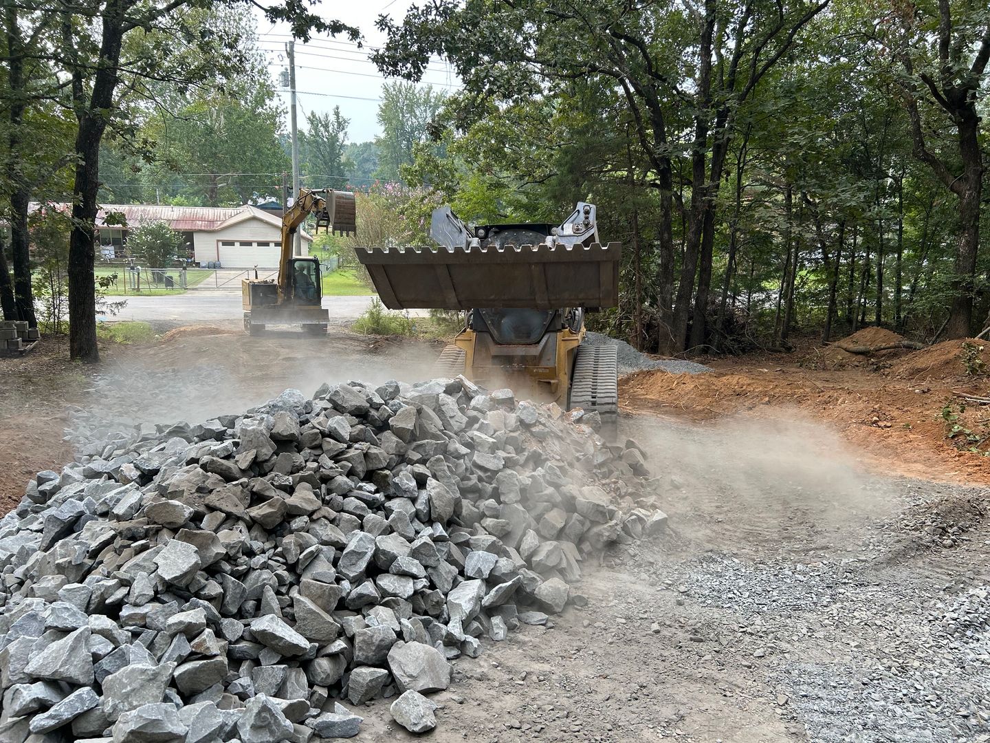 Excavator performing site development dirt work in Arkansas